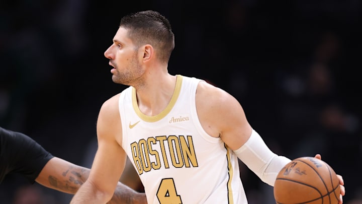 Mar 1, 2026; Boston, Massachusetts, USA; Boston Celtics center Nikola Vucevic (4) dribbles down the court defended by Philadelphia 76ers center Andre Drummond (1) during the first half at TD Garden. Mandatory Credit: Paul Rutherford-Imagn Images