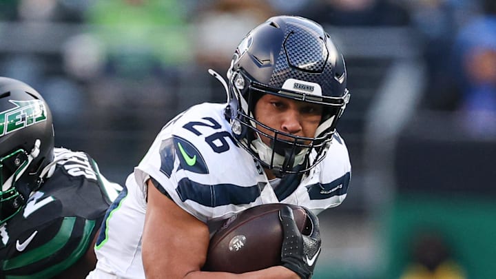 Dec 1, 2024; East Rutherford, New Jersey, USA; Seattle Seahawks running back Zach Charbonnet (26) carries the ball during the first half against the New York Jets at MetLife Stadium. Mandatory Credit: Vincent Carchietta-Imagn Images