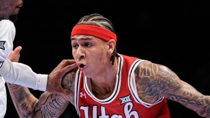 Mar 10, 2026; Kansas City, MO, USA; Utah Utes guard Terrence Brown (2) drives around Cincinnati Bearcats guard Day Day Thomas (1) during the second half at T-Mobile Center. Mandatory Credit: William Purnell-Imagn Images