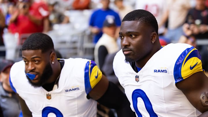 Dec 7, 2025; Glendale, Arizona, USA; Los Angeles Rams linebacker Byron Young (0) and Jared Verse (8) and against the Arizona Cardinals at State Farm Stadium. Mandatory Credit: Mark J. Rebilas-Imagn Images
