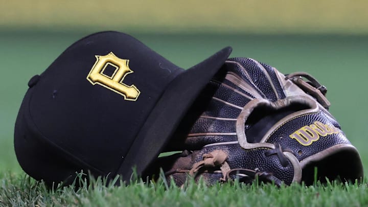 Sep 16, 2025; Pittsburgh, Pennsylvania, USA; A hat and glove belonging to Pittsburgh Pirates third baseman Jared Triolo (not pictured) on the field against the Chicago Cubs during the sixth inning at PNC Park. Sep 16, 2025; Pittsburgh, Pennsylvania, USA; A hat and glove belonging to Pittsburgh Pirates third baseman Jared Triolo (not pictured) on the field against the Chicago Cubs during the sixth inning at PNC Park.
