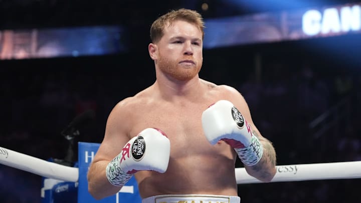 May 7, 2022; Las Vegas, Nevada, USA; Canelo Alvarez (pink trunks) and Dimitry Bivol (black trunks) box during their light heavyweight championship bout at T-Mobile Arena. Mandatory Credit: Joe Camporeale-Imagn Images