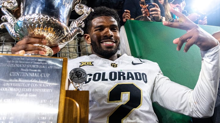 CU football quarterback Shedeur Sanders (2) poses with the Centennial Cup after beating CSU in the Rocky Mountain Showdown at Canvas Stadium on Saturday, Sept. 14, 2024, in Fort Collins, Colo.