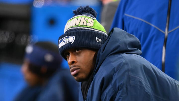 Dec 15, 2024; Seattle, Washington, USA; Seattle Seahawks quarterback Geno Smith (7) sits on the bench after an injury during the second half against the Green Bay Packers at Lumen Field. Mandatory Credit: Steven Bisig-Imagn Images
