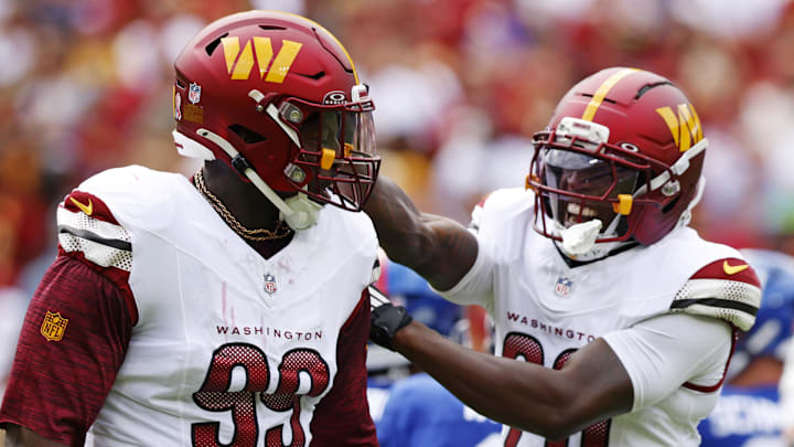 Washington Commanders defensive tackle Javon Kinlaw (99) celebrates with safety Quan Martin (20) 