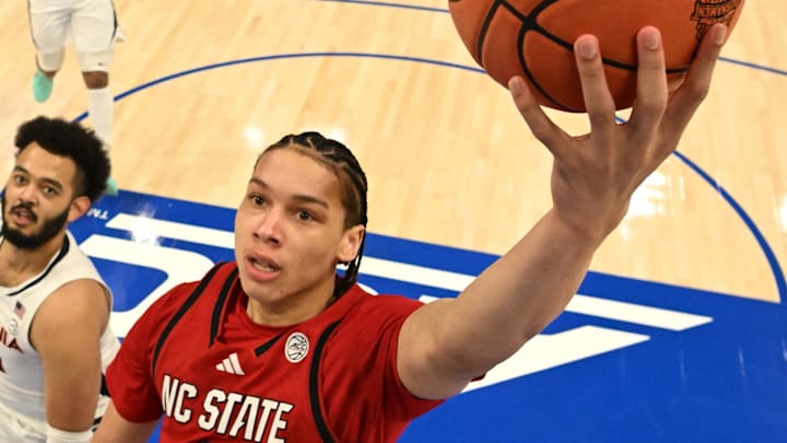 Mar 12, 2026; Charlotte, NC, USA; NC State Wolfpack guard Matt Able (3) scores as Virginia Cavaliers forward Devin Tillis (11) defends in the first half at Spectrum Center. Mandatory Credit: Bob Donnan-Imagn Images Mar 12, 2026; Charlotte, NC, USA; NC State Wolfpack guard Matt Able (3) scores as Virginia Cavaliers forward Devin Tillis (11) defends in the first half at Spectrum Center. Mandatory Credit: Bob Donnan-Imagn Images