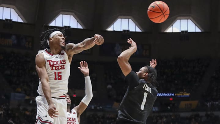 Texas Tech Red Raiders forward JT Toppin (15) blocks a shot from West Virginia Mountaineers guard Jasper Floyd (1) during the second half at Hope Coliseum.