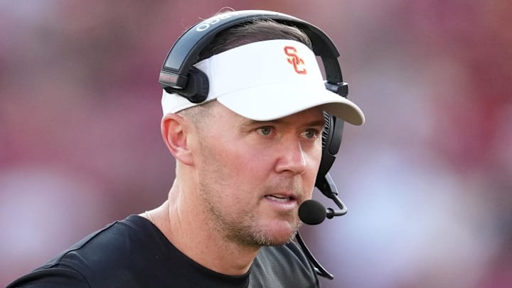 Aug 30, 2025; Los Angeles, California, USA; Southern California Trojans head coach Lincoln Riley talks with Southern California Trojans quarterback Husan Longstreet (4) in the second half against the Missouri State Bears at United Airlines Field at Los Angeles Memorial Coliseum. Mandatory Credit: Kirby Lee-Imagn Images