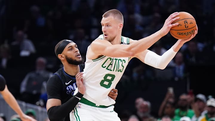 Jun 6, 2024; Boston, Massachusetts, USA; Boston Celtics center Kristaps Porzingis (8) controls the ball against Dallas Mavericks center Daniel Gafford (21) in the first quarter during game one of the 2024 NBA Finals at TD Garden. Mandatory Credit: David Butler II-Imagn Images