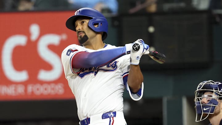 Apr 5, 2025; Arlington, Texas, USA; Texas Rangers second baseman Marcus Semien (2) hits a home run during the first inning against the Tampa Bay Rays at Globe Life Field. 