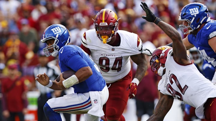Giants quarterback Russell Wilson (3) runs away from Washington Commanders defensive end Dorance Armstrong (92).