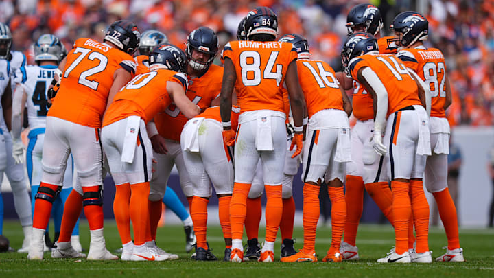 Oct 27, 2024; Denver, Colorado, USA; Denver Broncos offensive players huddle in the first half against the Carolina Panthers at Empower Field at Mile High. 