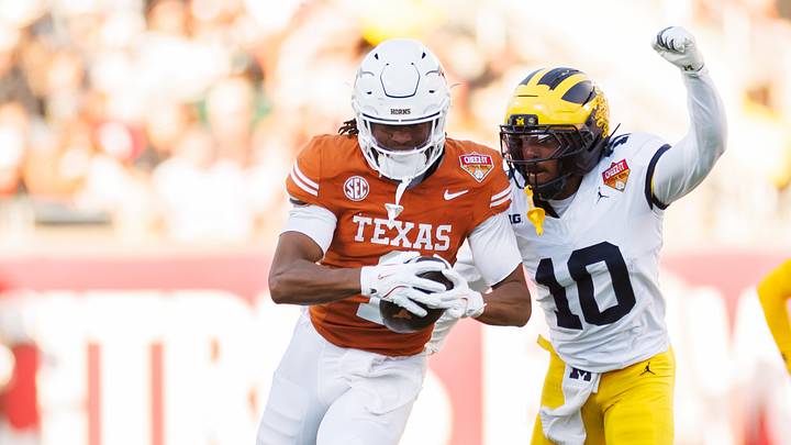 Texas Longhorns wide receiver Ryan Wingo (1) runs with the ball while Michigan Wolverines defensive back Zeke Berry (10) attempts to tackle during the first half at Camping World Stadium. Texas Longhorns wide receiver Ryan Wingo (1) runs with the ball while Michigan Wolverines defensive back Zeke Berry (10) attempts to tackle during the first half at Camping World Stadium.
