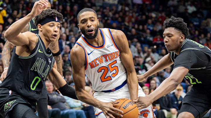 Dec 29, 2025; New Orleans, Louisiana, USA;  New York Knicks guard/forward Mikal Bridges (25) dribbles against New Orleans Pelicans center Derik Queen (22) and guard Jeremiah Fears (0) during the first half at Smoothie King Center. Mandatory Credit: Stephen Lew-Imagn Images