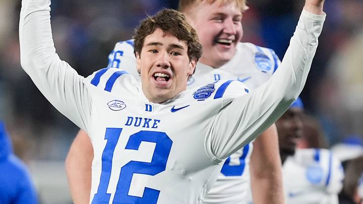 Dec 6, 2025; Charlotte, NC, USA; Duke Blue Devils quarterback Dan Mahan (12) celebrates defeating the Virginia Cavaliers during the 2025 ACC Championship game at Bank of America Stadium. Mandatory Credit: Jim Dedmon-Imagn Images