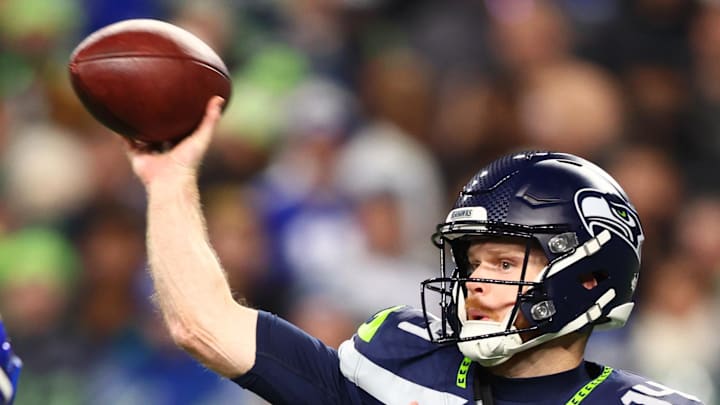 Seattle Seahawks quarterback Sam Darnold throws against Los Angeles Rams linebacker Jared Verse.