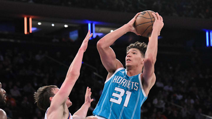 Oct 15, 2024; New York, New York, USA; Charlotte Hornets forward Tidjane Salaun (31) shoots the ball while being defended by New York Knicks guard Tyler Kolek (13) and New York Knicks forward Precious Achiuwa (5) during the second half at Madison Square Garden. Mandatory Credit: John Jones-Imagn Images