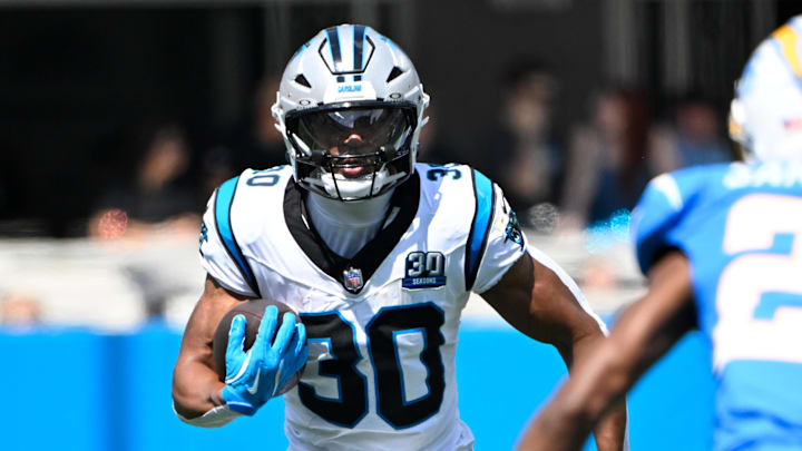 Sep 15, 2024; Charlotte, North Carolina, USA; Carolina Panthers running back Chuba Hubbard (30) with the ball as Los Angeles Chargers cornerback Asante Samuel Jr. (26) defends in the first quarter at Bank of America Stadium. Mandatory Credit: Bob Donnan-Imagn Images