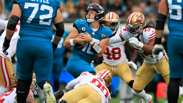 Jacksonville Jaguars quarterback Trevor Lawrence (16) spins from a host of San Francisco 49ers defenders during the first quarter of an NFL football game Sunday, Nov. 12, 2023 at EverBank Stadium in Jacksonville, Fla. [Corey Perrine/Florida Times-Union]
