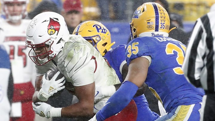 Oct 14, 2023; Pittsburgh, Pennsylvania, USA; Louisville Cardinals running back Isaac Guerendo (23) carries the ball against the Pittsburgh Panthers during the second quarter at Acrisure Stadium. Oct 14, 2023; Pittsburgh, Pennsylvania, USA; Louisville Cardinals running back Isaac Guerendo (23) carries the ball against the Pittsburgh Panthers during the second quarter at Acrisure Stadium.
