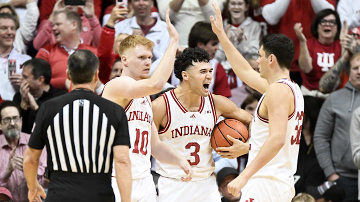 Indiana's Luke Goode (10), Anthony Leal (3) and Trey Galloway (32) celebrate against Purdue at Simon Skjodt Assembly Hall.