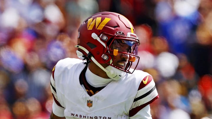 Washington Commanders quarterback Jayden Daniels runs the ball against New York Giants linebacker Brian Burns. Washington Commanders quarterback Jayden Daniels runs the ball against New York Giants linebacker Brian Burns.