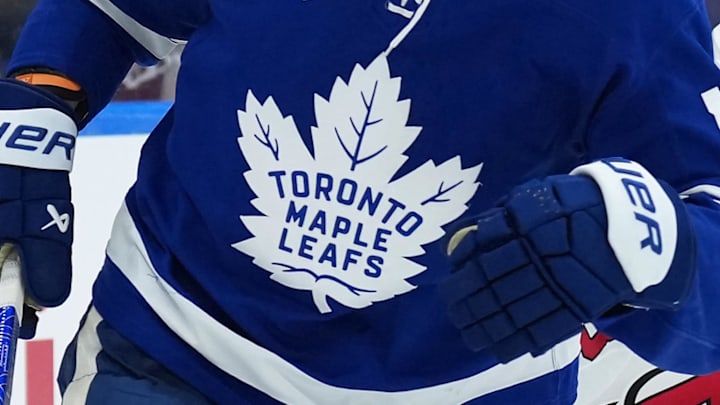 Dec 30, 2025; Toronto, Ontario, CAN; Toronto Maple Leafs center Steven Lorentz (18) battles for the puck with New Jersey Devils defenseman Luke Hughes (43) during the third period at Scotiabank Arena. Mandatory Credit: Nick Turchiaro-Imagn Images