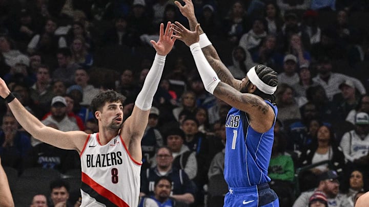 Jan 9, 2025; Dallas, Texas, USA; Dallas Mavericks guard Jaden Hardy (1) makes a jump shot over Portland Trail Blazers forward Deni Avdija (8) during the second quarter at the American Airlines Center. Mandatory Credit: Jerome Miron-Imagn Images