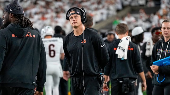 Injured Cincinnati Bengals quarterback Joe Burrow (9) walks the sideline with a headset in the second quarter of the NFL Week 7 game between the Cincinnati Bengals and the Pittsburgh Steelers at Paycor Stadium in downtown Cincinnati on Thursday, Oct. 16, 2025.