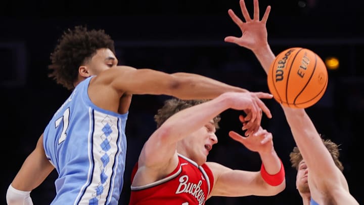 Dec 20, 2025; Atlanta, Georgia, USA; North Carolina Tar Heels guard Seth Trimble (7) and center Henri Veesaar (13) defend Ohio State Buckeyes center Christoph Tilly (13) in the second half at State Farm Arena. Mandatory Credit: Brett Davis-Imagn Images
