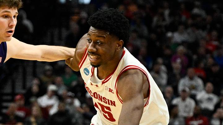 Mar 19, 2026; Portland, OR, USA; Wisconsin Badgers guard John Blackwell (25) drives against High Point Panthers guard Chase Johnston (99) during the second half of a first round game of the men's 2026 NCAA Tournament at Moda Center. Mandatory Credit: Troy Wayrynen-Imagn Images
