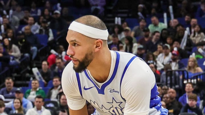 Orlando Magic guard Jalen Suggs handles the ball in front of Brooklyn Nets forward Noah Clowney.