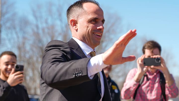 Iowa's new head men's basketball coach Ben McCollum waves at the assembled crowd while walking into his introductory press conference Tuesday, March 25, 2025 at Carver-Hawkeye Arena in Iowa City, Iowa.
