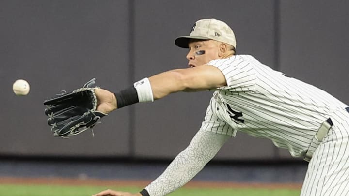 May 18, 2025; Bronx, New York, USA;  New York Yankees right fielder Aaron Judge (99) makes a diving catch in the second inning against the New York Mets at Yankee Stadium. Mandatory Credit: Wendell Cruz-Imagn Images