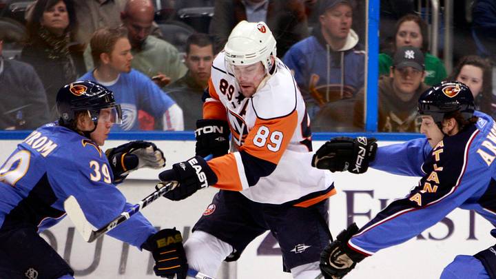 February 28, 2008; Atlanta, GA, USA; New York Islanders forwards (89) Mike Comrie gets checked between Atlanta Thrashers defenseman (39) Tobias Enstrom and forward (19) Colby Armstrong in the first period at Philips Arena. The Islanders defeated the Thrashers 5 to 4 in overtime. Mandatory Credit: Dale Zanine USA TODAY Sports