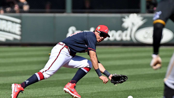 Feb 25, 2026; North Port, Florida, USA; Atlanta Braves shortstop Mauricio Dubon (14) dives for a ground ball in the third inning against the Pittsburgh Pirates during spring training at CoolToday Park. Mandatory Credit: Jonathan Dyer-Imagn Images