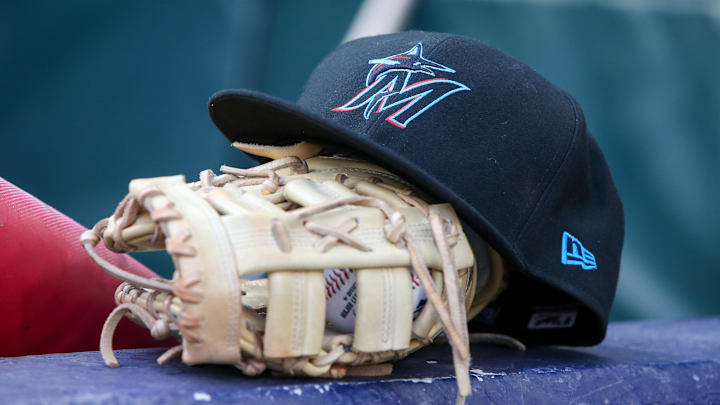 Apr 24, 2024; Atlanta, Georgia, USA; A detailed view of a Miami Marlins hat and glove in the dugout before a game against the Atlanta Braves at Truist Park. Mandatory Credit: Brett Davis-Imagn Images