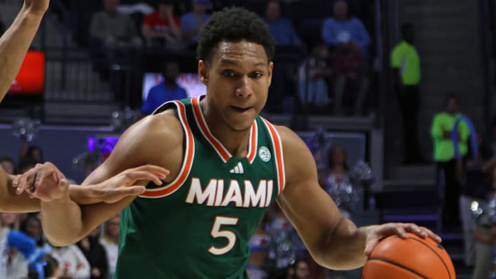 Dec 2, 2025; Oxford, Mississippi, USA; Miami Hurricanes forward Malik Reneau (5) drives to the basket as Mississippi Rebels guard Patton Pinkins (23) defends during the first half at The Sandy and John Black Pavilion at Ole Miss. Mandatory Credit: Petre Thomas-Imagn Images Dec 2, 2025; Oxford, Mississippi, USA; Miami Hurricanes forward Malik Reneau (5) drives to the basket as Mississippi Rebels guard Patton Pinkins (23) defends during the first half at The Sandy and John Black Pavilion at Ole Miss. Mandatory Credit: Petre Thomas-Imagn Images