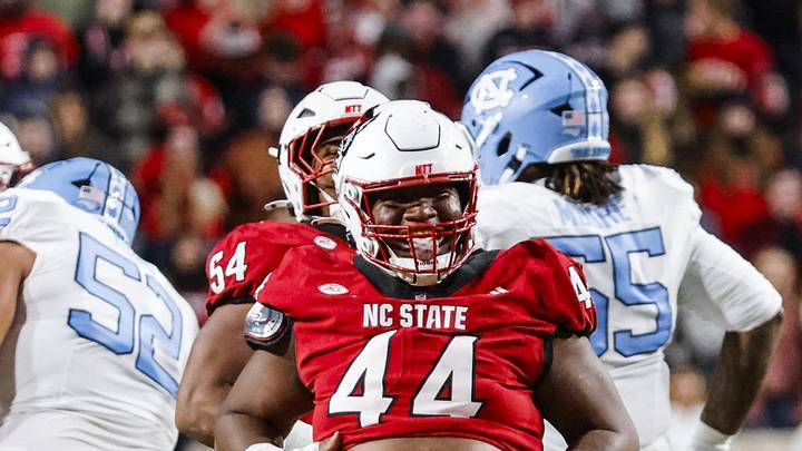 Nov 29, 2025; Raleigh, North Carolina, USA;  NC State Wolfpack defensive tackle Brandon Cleveland (44) reacts to his tackle during the first half of the game against the North Carolina Tar Heels at Carter-Finley Stadium.  Mandatory Credit: Jaylynn Nash-Imagn Images