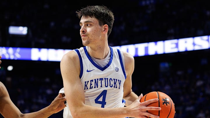 Nov 4, 2025; Lexington, Kentucky, USA; Kentucky Wildcats forward Andrija Jelavic (4) handles the ball against Nicholls Colonels forward Sincere Malone (5) during the second half at Rupp Arena at Central Bank Center. Mandatory Credit: Jordan Prather-Imagn Images