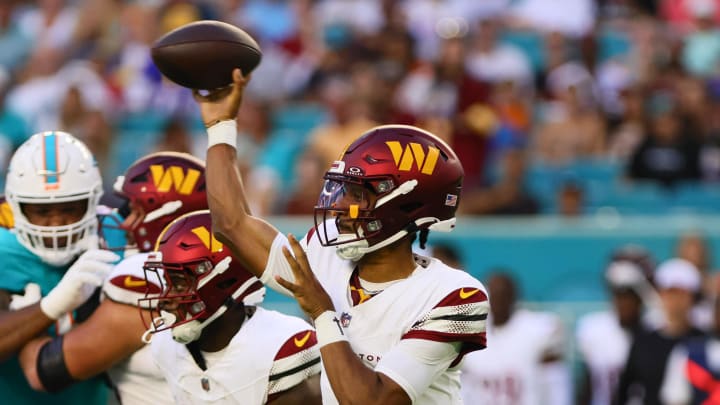 Aug 17, 2024; Miami Gardens, Florida, USA; Washington Commanders quarterback Jayden Daniels (5) throws the football against the Miami Dolphins during the first quarter of a preseason game at Hard Rock Stadium. Mandatory Credit: Sam Navarro-USA TODAY Sports