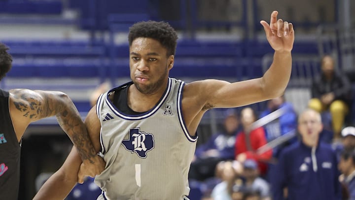 Jan 24, 2024; Houston, Texas, USA; Rice Owls guard Noah Shelby (1) defends against Florida Atlantic Owls guard Jalen Gaffney (12) during the second half at Tudor Fieldhouse. 