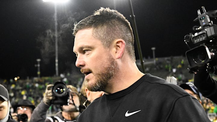 Dec 20, 2025; Eugene, OR, USA; James Madison Dukes head coach Bob Chesney and Oregon Ducks head coach Dan Lanning greet one another after the game at Autzen Stadium. Mandatory Credit: Troy Wayrynen-Imagn Images