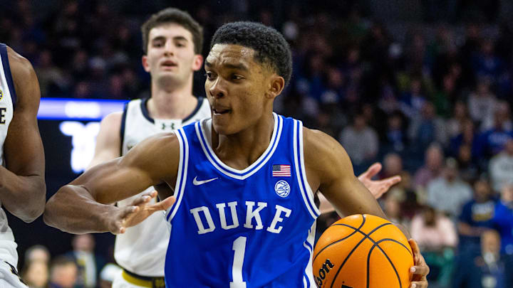 Feb 24, 2026; South Bend, Indiana, USA; Duke Blue Devils guard Caleb Foster (1) drives as Notre Dame Fighting Irish guard Sir Mohammed (13) defends during the second half at Purcell Pavilion at the Joyce Center. Mandatory Credit: Michael Caterina-Imagn Images