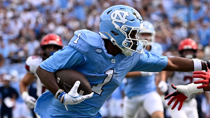 Sep 13, 2025; Chapel Hill, North Carolina, USA; North Carolina Tar Heels wide receiver Jordan Shipp (1) scores a touchdown as Richmond Spiders defensive back Lee Bruner IV (19) defends in the first quarter at Kenan Stadium. Mandatory Credit: Bob Donnan-Imagn Images
