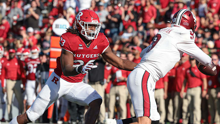 Oct 22, 2022; Piscataway, New Jersey, USA; Rutgers Scarlet Knights defensive lineman Wesley Bailey (23) rushes Indiana Hoosiers quarterback Connor Bazelak (9) resulting in an interception during the second half at SHI Stadium. Mandatory Credit: Vincent Carchietta-Imagn Images