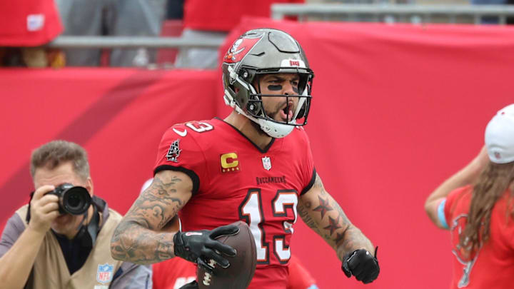 Dec 29, 2024; Tampa, Florida, USA; Tampa Bay Buccaneers wide receiver Mike Evans (13) celebrates after he scores a touchdown  against the Carolina Panthers during the second quarter at Raymond James Stadium. Mandatory Credit: Kim Klement Neitzel-Imagn Images