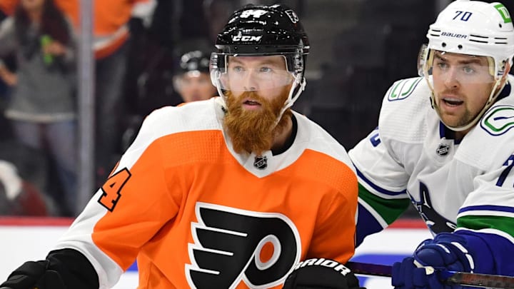 Oct 15, 2021; Philadelphia, Pennsylvania, USA; Philadelphia Flyers defenseman Ryan Ellis (94) and Vancouver Canucks left wing Tanner Pearson (70) battle at Wells Fargo Center. Mandatory Credit: Eric Hartline-Imagn Images
