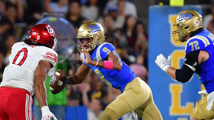 Aug 30, 2025; Pasadena, California, USA; UCLA Bruins quarterback Nico Iamaleava (9) runs the ball against Utah Utes defensive end Logan Fano (0) during the first half at Rose Bowl. Mandatory Credit: Gary A. Vasquez-Imagn Images