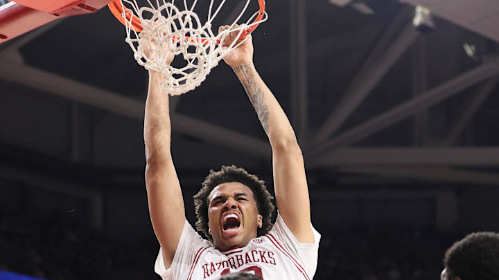 Arkansas Razorbacks forward Malique Ewin (12) dunks the ball as Texas A&M Aggies forward Federiko Federiko (33) defends during the second half at Bud Walton Arena. Arkansas won 99-84.
